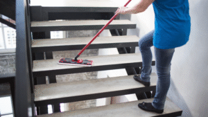 Janitor mopping stairs in a commercial Chicago property
