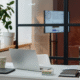 Well-lit Chicago office desk with plants and minimalist setup, ready for professional cleaning.