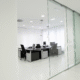 Pristine office space with glass partitions and clean white floors