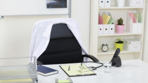 Doctor’s office desk with stethoscope, lab coat, and medical files
