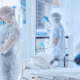 Professional hospital cleaning crew disinfecting a patient room