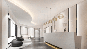 Contemporary office lobby with modern lighting and a sleek white reception desk.
