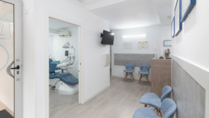 Dental clinic interior with treatment chair and reception seating.