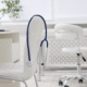Bright white medical office with desk, chair, and exam table.