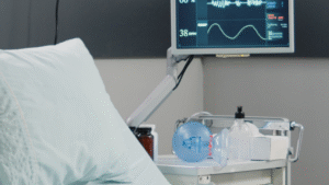 Hospital bed with clean bedding and sanitized medical monitor.