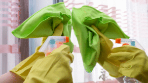 Detailed glass cleaning with spray bottle and microfiber cloth after construction.