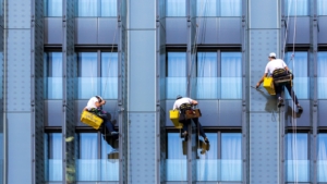 Professional window cleaners working on a high-rise building in Chicago