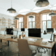 Modern office with brick walls, desks, and large windows