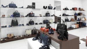 Clean and organized retail display with shoes and handbags neatly arranged