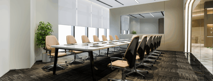 Sleek boardroom with long table, high-back chairs, and clean carpet