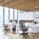 Bright executive office with large windows, clean floors, and city view
