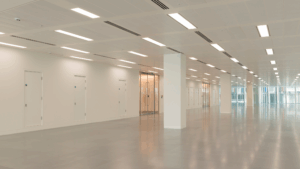 Wide, bright commercial interior with tile flooring and clean lighting