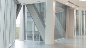 Floor-to-ceiling glass windows in a modern office building