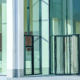 Clean exterior glass commercial building entryway in natural light