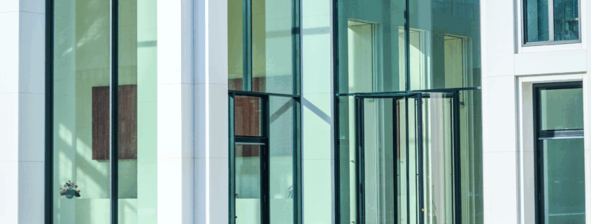 Clean exterior glass commercial building entryway in natural light