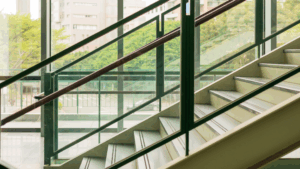 Interior glass walls and staircase in a modern commercial space.