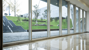 Clean indoor glass panels facing trees and grass outside.