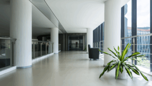 Quiet office corridor with clean floors and glass railing