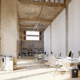 Open-concept office space with white desks and floor-to-ceiling curtains