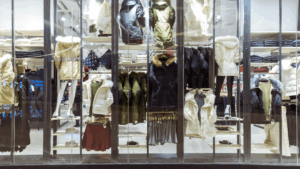 Winter clothing display behind a clean glass storefront