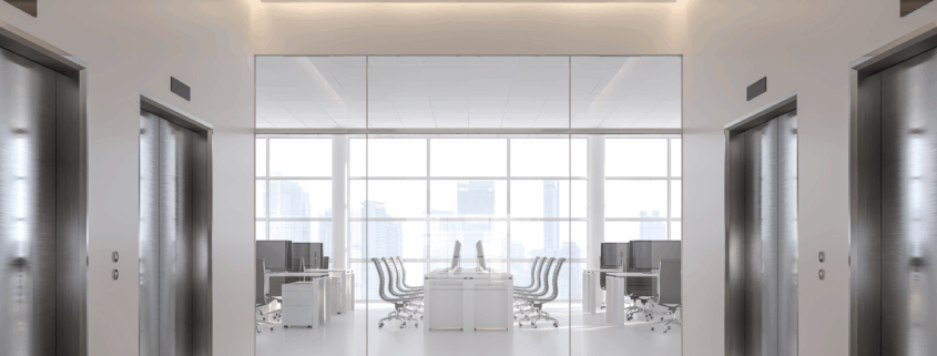 Pristine hallway with elevators and a view into a spotless office