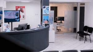 Clean and organized medical reception area with digital signage and heart health posters
