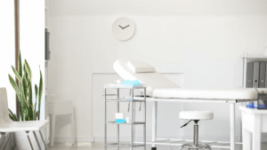 Clean treatment bed with neatly arranged supplies in a bright clinical setting