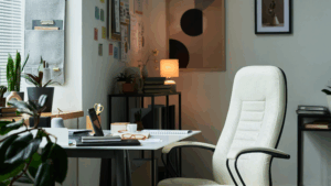 Cozy office corner with a clean desk, organized books, and indoor plants.