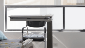 Hospital patient room desk and chair in a sanitized recovery environment