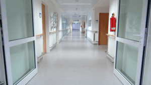 Clean hospital hallway connecting multiple departments