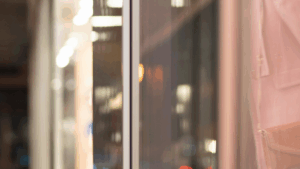 Clean storefront windows reflecting city lights on a gray winter evening