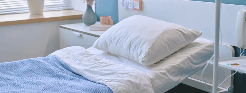 Clean hospital patient room with fresh bedding and calm lighting