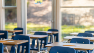 Classroom filled with desks and sunlight coming through clean windows