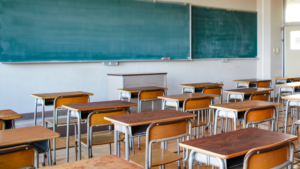 High school classroom with desks arranged and clean board ready for instruction