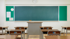 Elementary classroom with desks and board cleaned and ready for students