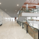 Modern multi-level commercial interior with walkways, railings, and open space