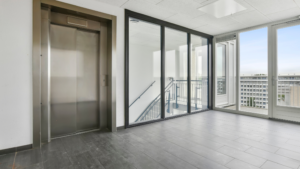 Commercial elevator lobby with clean floors and glass panels