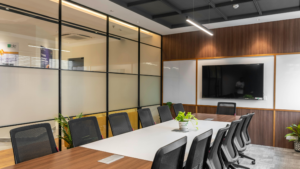 Modern meeting room with clean table, decorative shelving, and bright lighting.