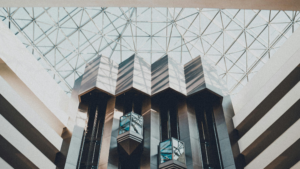 Glass ceiling structure in modern commercial building letting natural light inside