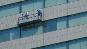 Workers cleaning high-rise windows using equipment for Professional Window Cleaning in Chicago