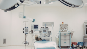 Modern hospital operating room with surgical equipment and patient table