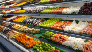 Grocery store produce section with fresh fruits and clean display shelves