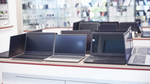 Electronics store display with laptops and clean glass surfaces