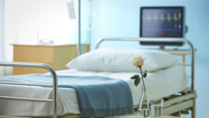 Hospital bed with monitoring equipment in a clean and prepared room
