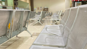 Empty clinic waiting room with aligned seating