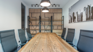 Modern office meeting room with large wooden table and chairs