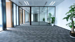 Empty office space with clean carpet and glass walls