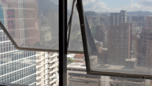 Dirty commercial office window reducing visibility and natural light inside the building.