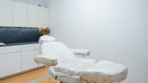 Clean medical treatment chair prepared inside a modern procedure room.