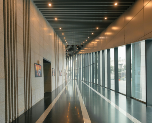 Clean commercial hallway with polished floors and natural light
